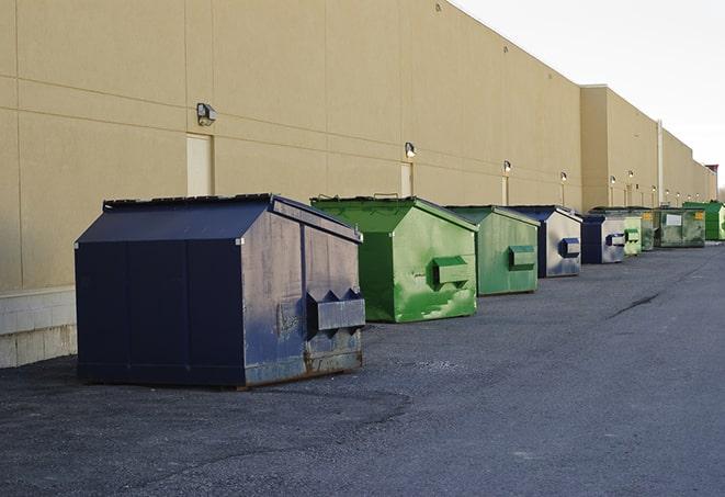 a group of construction workers taking a break near a dumpster in Austintown